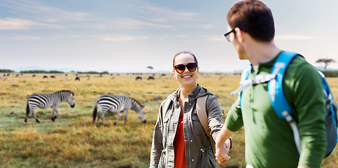 Image showing smiling couple with backpacks traveling in africa