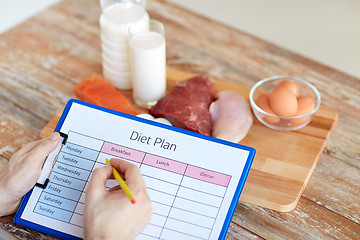 Image showing man with food and diet plan at home