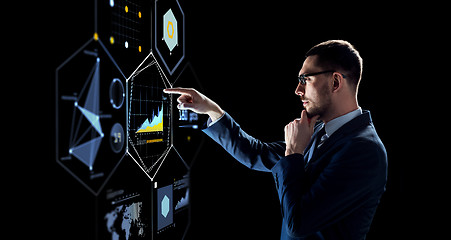 Image showing businessman with virtual screen over black