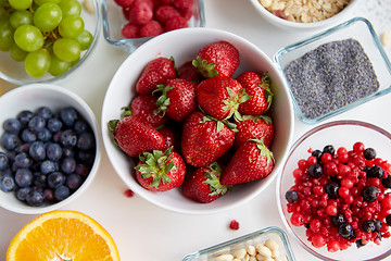 Image showing fruits and berries in bowls on table