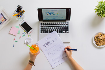 Image showing hands with laptop and papers at office table