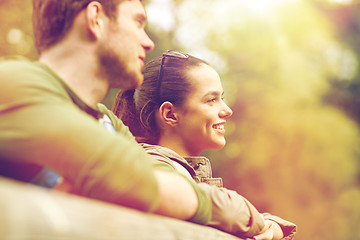 Image showing smiling couple with backpacks on bridge in nature