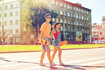 Image showing teenage couple with skateboards on city street