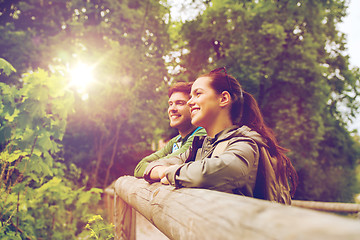 Image showing smiling couple with backpacks in nature