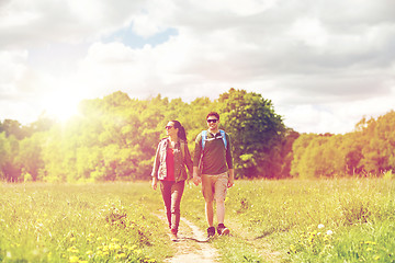 Image showing happy couple with backpacks hiking outdoors