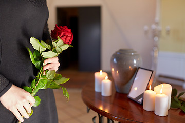 Image showing woman with cremation urn at funeral in church