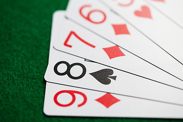 Image showing poker hand of playing cards on green casino cloth