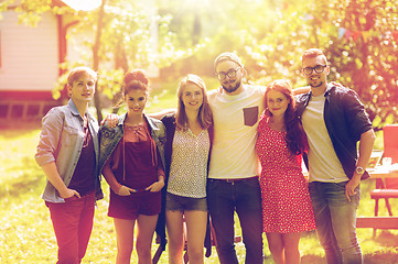 Image showing happy teenage friends hugging at summer garden