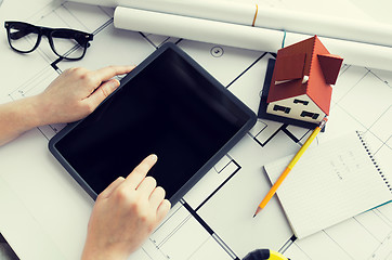 Image showing close up of hand with blueprint and tablet pc