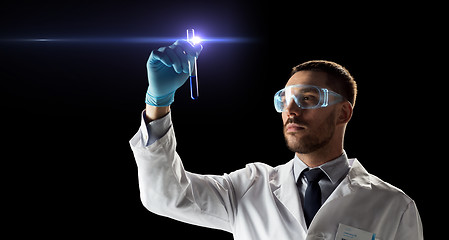 Image showing scientist in safety glasses with test tube