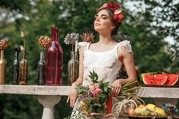 Image showing Wedding decoration in the style of boho, floral arrangement, decorated table in the garden.