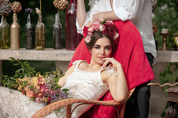 Image showing Wedding decoration in the style of boho, floral arrangement, decorated table in the garden.