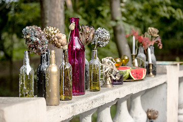 Image showing Burning candle in the vintage black bottle