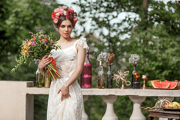 Image showing Wedding decoration in the style of boho, floral arrangement, decorated table in the garden.