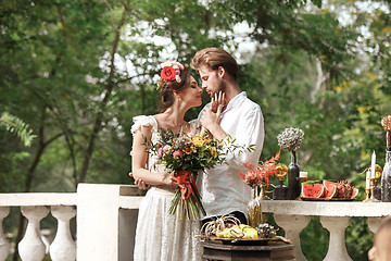 Image showing Wedding decoration in the style of boho, floral arrangement, decorated table in the garden.