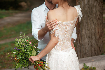 Image showing Wedding decoration in the style of boho, floral arrangement, decorated table in the garden.