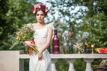 Image showing Wedding decoration in the style of boho, floral arrangement, decorated table in the garden.