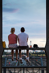 Image showing Young couple on romantic date on urban railway bridge, Munich, Germany.