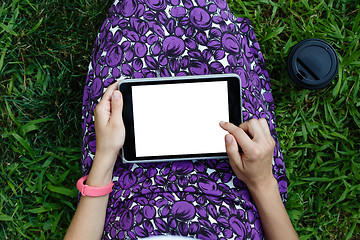 Image showing Woman on grass with tablet