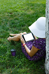 Image showing Woman on grass with tablet