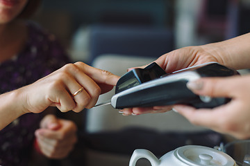 Image showing Woman paying his bill in restaurant