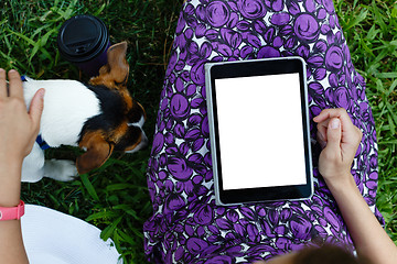 Image showing Woman on grass with tablet
