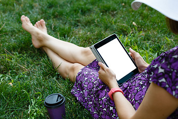 Image showing Woman on grass with tablet