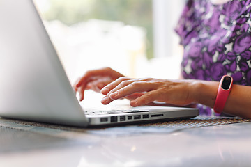 Image showing Woman working with laptop in a cafe.