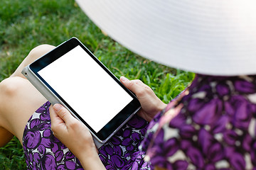 Image showing Woman on grass with tablet