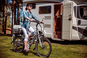 Image showing Woman on electric bike resting at the campsite