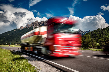 Image showing Fuel truck rushes down the highway in the background the Alps. T