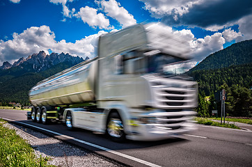 Image showing Fuel truck rushes down the highway in the background the Alps. T