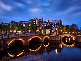 Image showing Amterdam canal, bridge and medieval houses in the evening