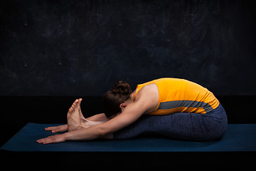 Image showing Woman practices Ashtanga Vinyasa yoga asana Paschimottanasana