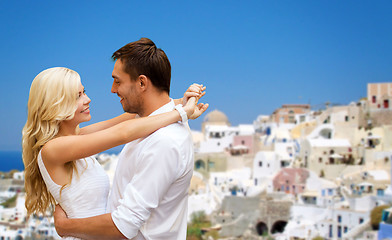 Image showing happy couple hugging over santorini island