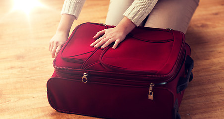 Image showing close up of woman packing travel bag for vacation