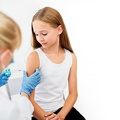 Image showing doctor with syringe making injection to girl