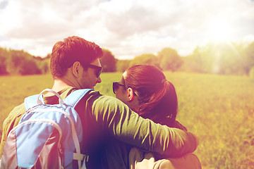 Image showing happy couple with backpacks hiking outdoors