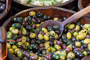 Image showing Olives in wooden bowls with serving spoon.