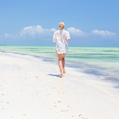 Image showing Happy woman having fun, enjoying summer, running joyfully on tropical beach.