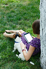 Image showing Woman on grass with tablet