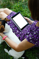 Image showing Woman on grass with tablet