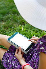 Image showing Woman on grass with tablet