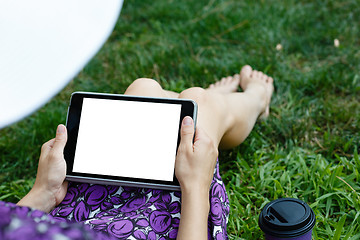 Image showing Woman on grass with tablet