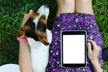 Image showing Woman on grass with tablet