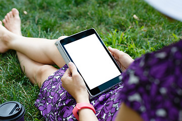 Image showing Woman on grass with tablet