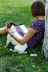 Image showing Woman on grass with tablet