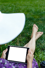 Image showing Woman on grass with tablet