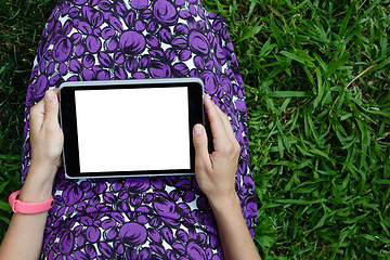 Image showing Woman on grass with tablet