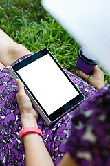 Image showing Woman on grass with tablet